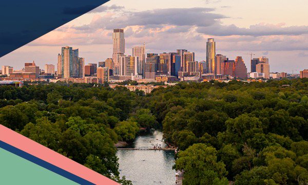 Aerial view of Barton Springs Municipal Pool surrounded by trees in Zilker Park with the Austin skyline in the backyard