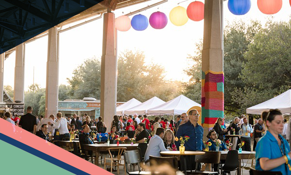 A crowd of people network under a pavilion in Austin, Texas, as part of the NOW & NEXT, A DHL Logistics Summit