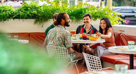 Four people enjoy patio dining along South Congress Avenue in Austin, Texas