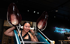 A woman engages with the interactive exhibit 