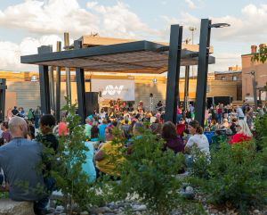 A crowd watching live music at an outdoor pavilion