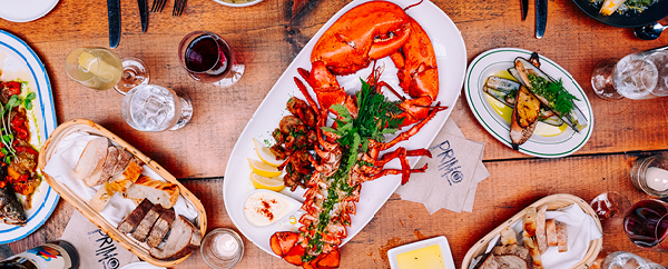 Tablescape with lobster, clams, bread and wine. 