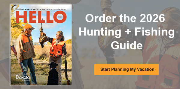 Image of a travel guide cover with people hunting birds and text that reads: Order the 2026 Hunting + Fishing Guide. Start Planning My Vacation