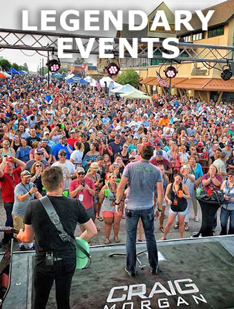 View from behind of musicians on stage at an outdoor concert, with a large crowd in front of them and overlay text that reads: Legendary Events