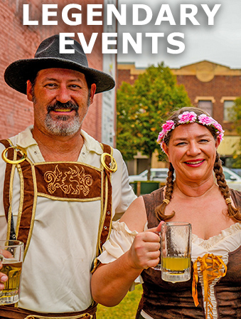 A smiling man and woman wearing traditional German attire and holding a stein of beer, with overlay text that reads: Legendary Events