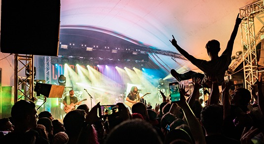 A person crowd-surfs while watching a band at the open-air Waller Creek Amphitheater at Stubb’s Bar-B-Q in Austin, Texas