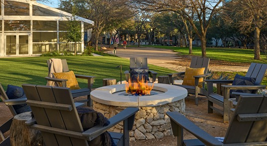 Adirondack chairs surround an outdoor fire pit at the Renaissance Austin Hotel in Austin, Texas