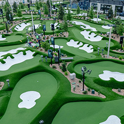 Putting courses with sand traps ready for mini golfers at PopStroke Cedar Park near Austin, Texas