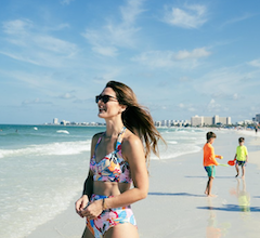 mom and kids on lido beach outside of their resort