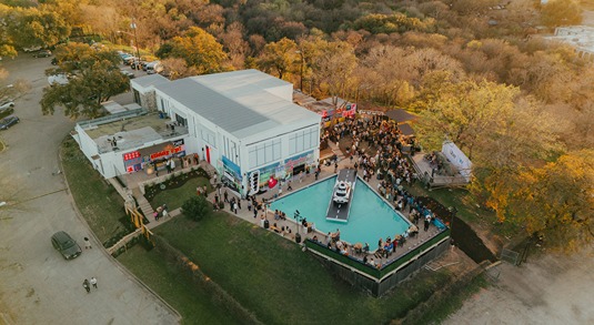 Aerial view of The High Road on Dawson, a two-story event venue with an outdoor swimming pool in Austin, Texas.