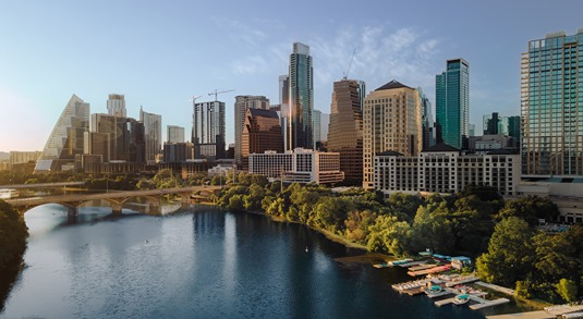 View of the Austin, Texas skyline, with bridges and docks across Lady Bird Lake