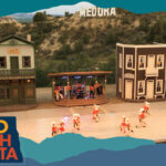 Overhead view of a musical stage production, with overlay text that reads: Hello North Dakota