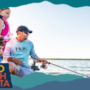 A man and two kids fishing on a lake, with overlay text that reads: Hello North Dakota