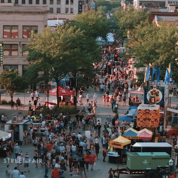 Aerial view of a crowd at an outdoor event on a street