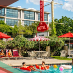 People lounge poolside and float on inner tubes in the pool at the retro Austin Motel on South Congress Avenue in Austin, Texas