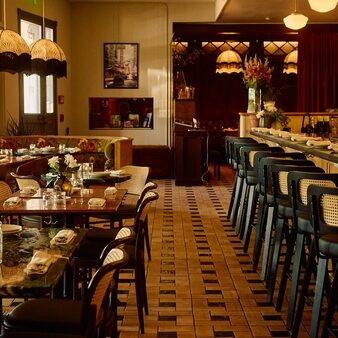 Table, booth and bar seating inside Siti, a Southeast Asian restaurant in East Austin, Texas