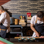 Two chefs prepare dishes in the kitchen of Craft Omakase, a fine dining Japanese restaurant in Austin, Texas.