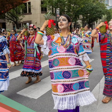 Women dressed in colorful costumes march in the Viva la Vida Festival parade in Austin, Texas